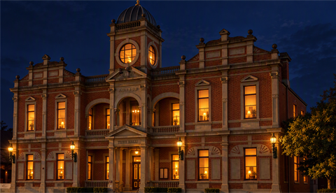 An image of Castlemaine Town Hall with Orange lights inside