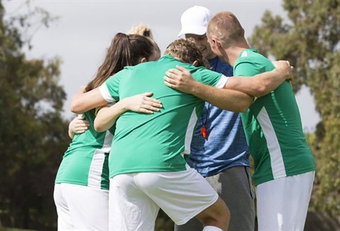 Soccer players huddling
